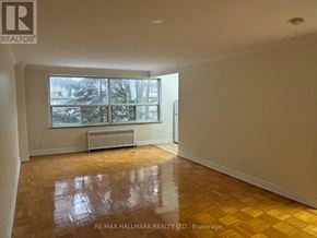 Toronto (Yonge-St. Clair) house for rent - A room with a large window and a radiator on the wall.