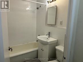 Toronto (Yonge-St. Clair) house for rent - A white bathroom with a sink, toilet and bathtub.
