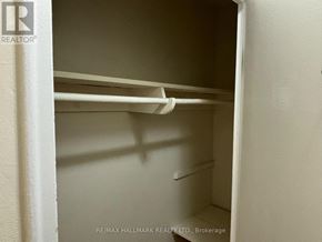 Toronto (Yonge-St. Clair) house for rent - A white closet with shelves and a RE/MAX Hallmark Realty Ltd. logo.