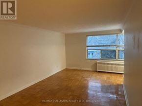 Toronto (Yonge-St. Clair) house for rent - A room with a window and a radiator on the floor.