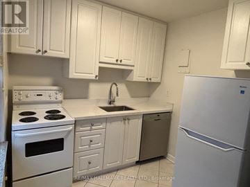 Toronto (Yonge-St. Clair) house for rent - A kitchen with white cabinets and appliances.