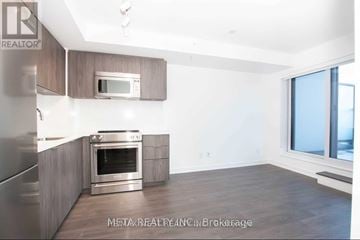 Toronto (Islington-City Centre West) condo for rent - A modern kitchen with a stainless steel refrigerator, oven, and microwave.