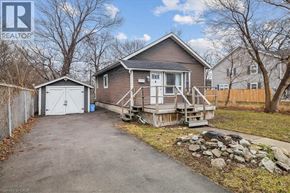 Hamilton apartment for rent - A house with a garage and a driveway in front of it.