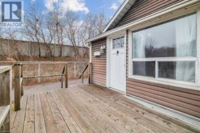 Hamilton apartment for rent - A wooden deck with a white door and a window is visible.