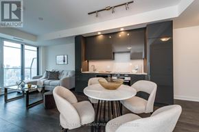 Toronto (Waterfront Communities) condo for rent - A modern kitchen with a dining table and chairs.