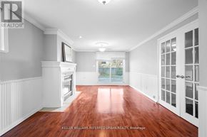 Toronto (Centennial Scarborough) apartment for rent - A spacious room with wood flooring and white walls.