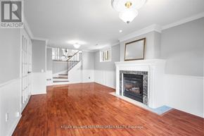 Toronto (Centennial Scarborough) apartment for rent - A spacious room with a fireplace and wood flooring.