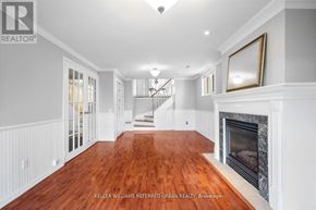Toronto (Centennial Scarborough) apartment for rent - A spacious living room with wood flooring and a fireplace.