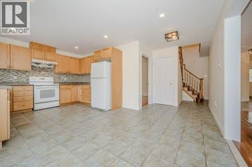 Hamilton apartment for rent - A kitchen with a white refrigerator and wooden cabinets.
