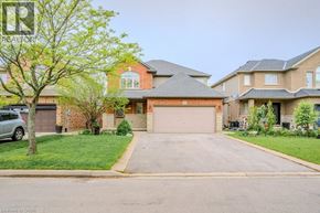 Hamilton apartment for rent - A real estate image of a house with a driveway and a tree.