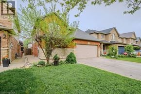 Hamilton apartment for rent - A well-maintained house with a large front yard and a driveway.