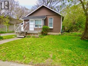 Hamilton (Hamilton Beach) apartment for rent - A house with a garage and a driveway in front of it.