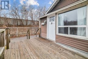 Hamilton (Hamilton Beach) apartment for rent - A wooden deck with a white door and a window.