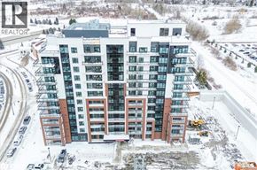 Clarington (Bowmanville) condo for rent - A large building with a lot of windows and a sign that says REALTOR.