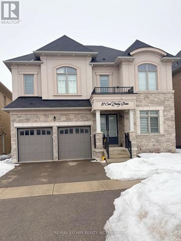 Brampton (Toronto Gore Rural Estate) apartment for rent - A two-story house with a balcony and a garage.