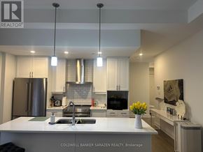 Ottawa condo for rent - A modern kitchen with a white countertop and stainless steel appliances.