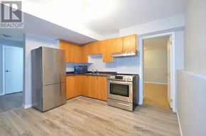 Barrie (Grove East) apartment for rent - A kitchen with wooden cabinets and stainless steel appliances.
