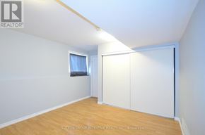 Barrie (Grove East) apartment for rent - A room with a sliding door and a window with a curtain.
