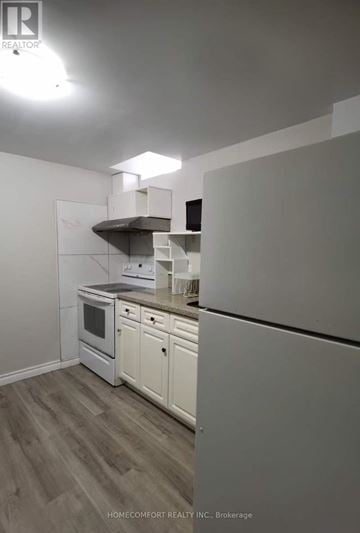 Toronto (Agincourt North) apartment for rent - A kitchen with a white oven and cabinets.