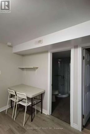 Toronto (Agincourt North) apartment for rent - A small room with a table and chairs and a doorway leading to a bathroom.