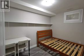 Toronto (Agincourt North) apartment for rent - A bedroom with a bed, desk, and chairs.