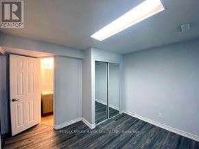 Toronto (Highland Creek) apartment for rent - A room with a door and a window with a light on.