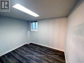 Toronto (Highland Creek) apartment for rent - A room with a window and a wooden floor.