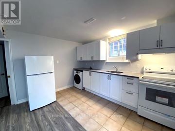 Toronto (Highland Creek) apartment for rent - A kitchen with white appliances and cabinets.