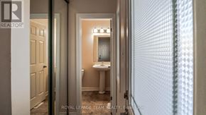 Ottawa townhouse for rent - A hallway with a white door and a white bathroom visible through the door.