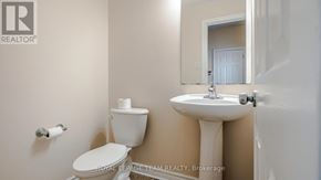 Ottawa townhouse for rent - A white toilet and sink in a bathroom.