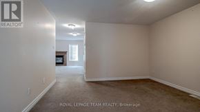 Ottawa townhouse for rent - A room with a carpet floor and a doorway leading to another room.
