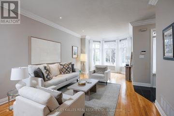 Mississauga (Port Credit) townhouse for rent - A well-lit living room with a white sofa and a coffee table.