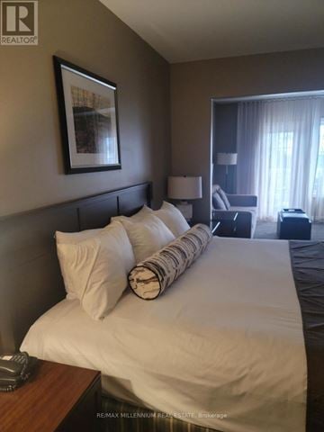 Oro-Medonte (Horseshoe Valley) condo for rent - A bedroom with a large bed and a picture frame on the wall.