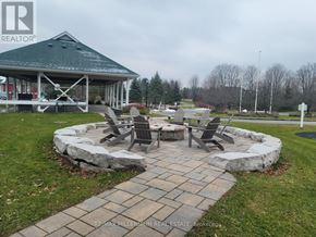 Oro-Medonte (Horseshoe Valley) condo for rent - A gazebo is surrounded by a stone wall and chairs are placed around a fire pit.