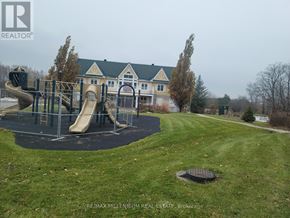 Oro-Medonte (Horseshoe Valley) condo for rent - A playground with a slide and a yellow house in the background.