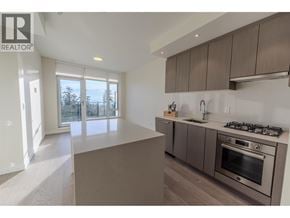 Vancouver apartment for rent - A modern kitchen with a stainless steel oven and wooden cabinets.