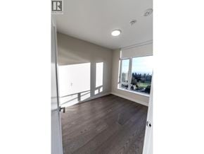 Vancouver apartment for rent - A room with a wooden floor and a large window.