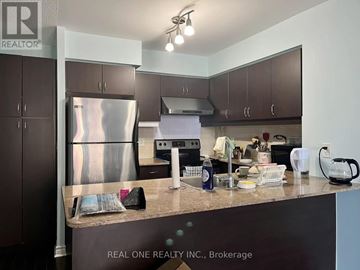 Toronto (Bayview Village) condo for rent - A kitchen with a stainless steel refrigerator and a countertop with various items on it.
