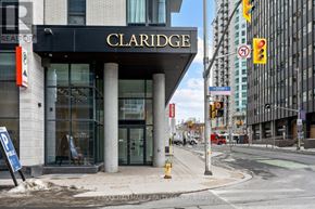 Ottawa condo for rent - A modern kitchen with white cabinets and stainless steel appliances.