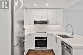 Ottawa condo for rent - A modern kitchen with a large window and a sink.