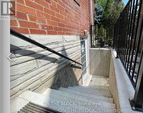 Toronto (Wexford-Maryvale) apartment for rent - A set of stairs leading up to a black railing with the words "ON THE BLOCK, Brokerage" written on the image.