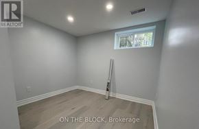 Toronto (Wexford-Maryvale) apartment for rent - A room with a window and a brokerage sign on the wall.