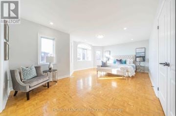 Markham (Milliken Mills East) apartment for rent - A living room with a grey couch and a wooden floor.
