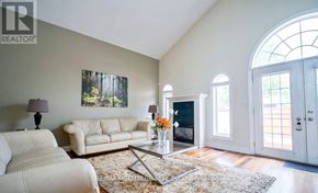 Niagara Falls (Forestview) apartment for rent - A living room with a white couch, a coffee table, and a painting on the wall.