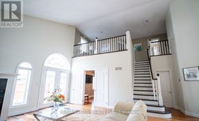 Niagara Falls (Forestview) apartment for rent - A spacious living room with a staircase and a fireplace.