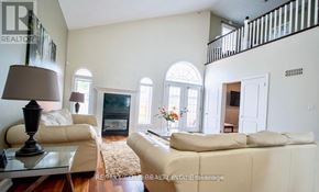 Niagara Falls (Forestview) apartment for rent - A living room with a white couch, a glass coffee table, and a fireplace.