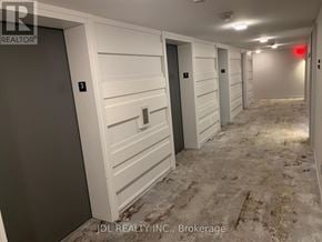 Toronto (Bay Street Corridor) condo for rent - A hallway with doors numbered 3 and 4.