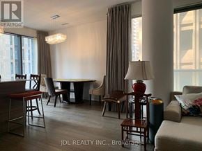 Toronto (Bay Street Corridor) condo for rent - A well-lit room with a dining table and chairs.