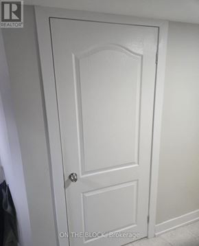 Toronto (Eglinton East) apartment for rent - A white door with a black handle and a brokerage logo on the top left.