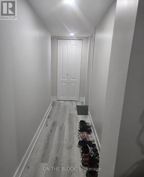 Toronto (Eglinton East) apartment for rent - A hallway with a door at the end and a green bin on the floor.